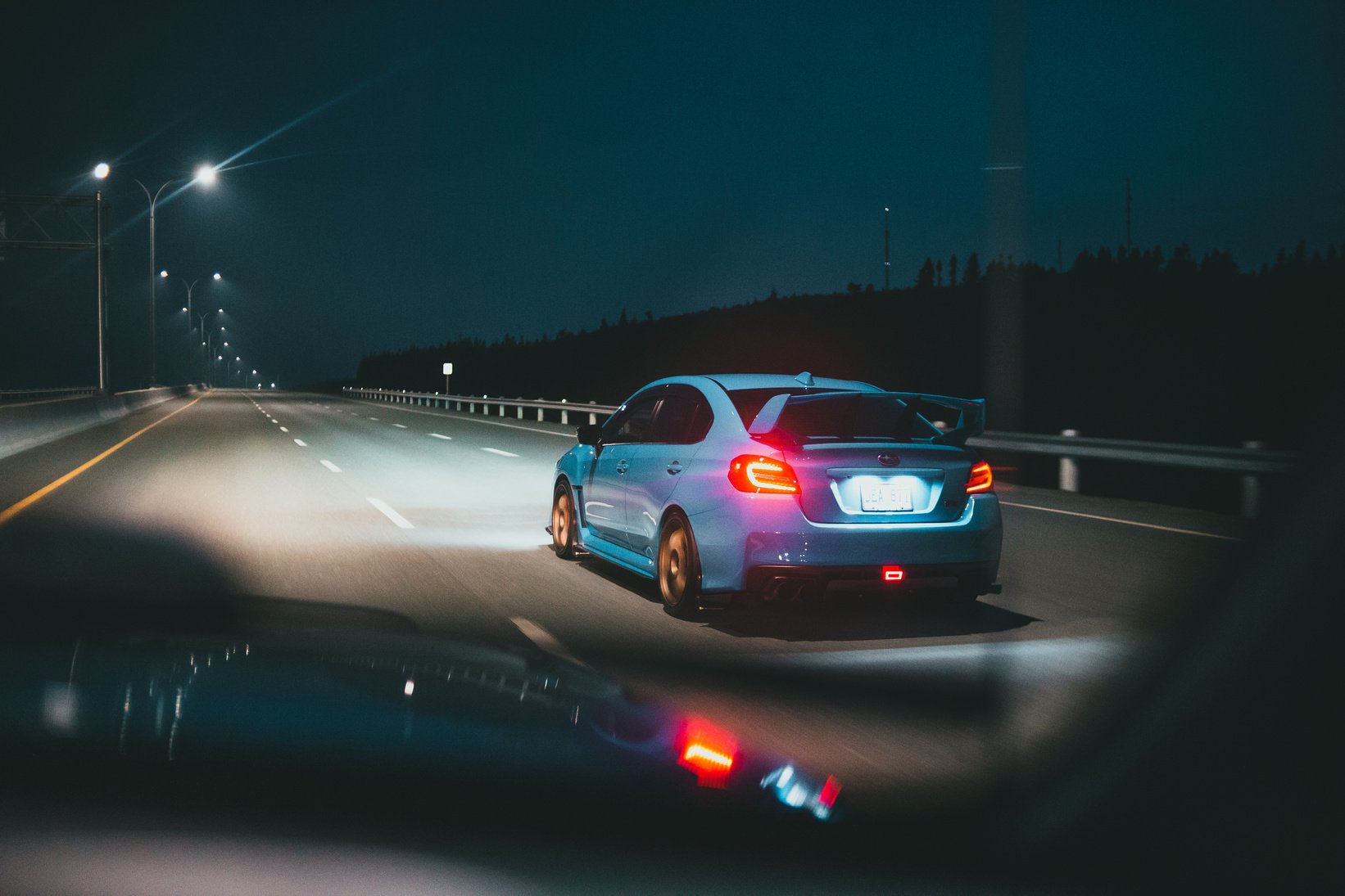 Back View of Subaru Car on Highway